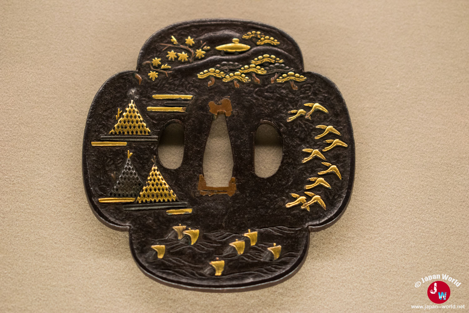 Tsuba décorée d'un paysage et de motifs dorés